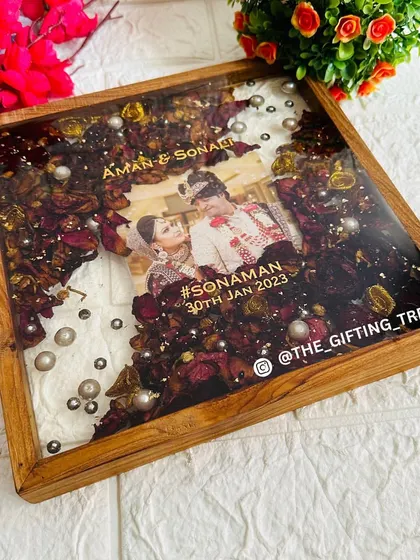 An angled view showing the glossy resin and the arrangement of the couple's photo, names, and wedding hashtag.