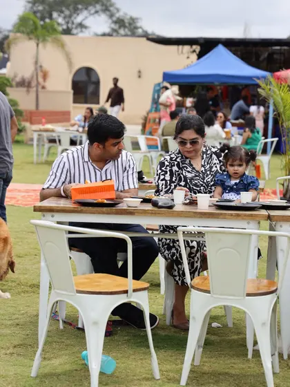 A candid shot of a family enjoying the brunch buffet in our spacious outdoor area. There's plenty of room for everyone to relax and have a good time.