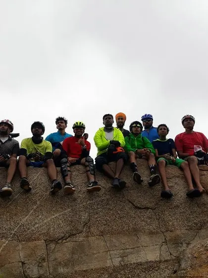 A wide shot of the group relaxing on a rock, a common sight on our adventurous rides.