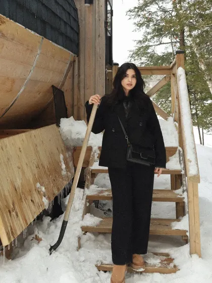 A full-length shot with a shovel, ready to clear some snow at the Parry Sound cabin.