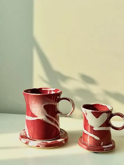 The Flamingo series cups and mugs with matching coasters. The bright, energetic glaze is perfect for adding a pop of color to your day.