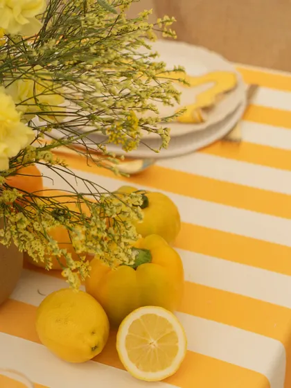 A close-up of the fresh citrus elements on the table, which added a sensory dimension to the summery, yellow-themed decor.