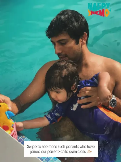 Using a toy, this dad engages his child, making learning a shared and playful experience.