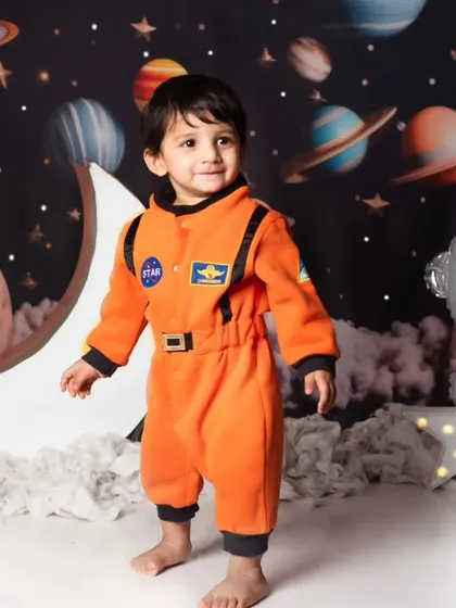 Dressed in a full astronaut suit, this little one is ready for his cosmic adventure in our detailed space-themed studio setup.