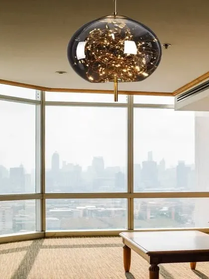 This crystal glass globe hanging light is filled with LED fairy lights, creating a magical, starry effect. The antique copper finish adds a touch of warmth, making it a stunning centerpiece for any room.