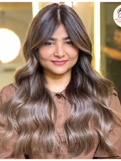From roots to tips, every strand tells a story. This ash-toned balayage is bold, bright, and beautifully colored.