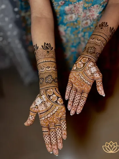 Another angle of Kruthi's intricate bridal mehendi, showcasing the symmetry and flawless application of the design that extends up the forearms.