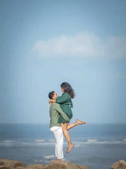 A classic, joyful lift against the bright blue sky. This pre-wedding photo is full of energy and happiness, perfectly showcasing the couple's love.