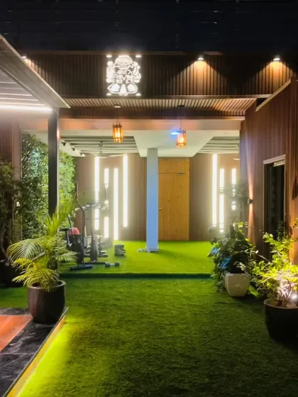 Looking through the completed Model Town terrace, this view shows the pathway leading from the seating area to the outdoor gym, all under ambient lighting.