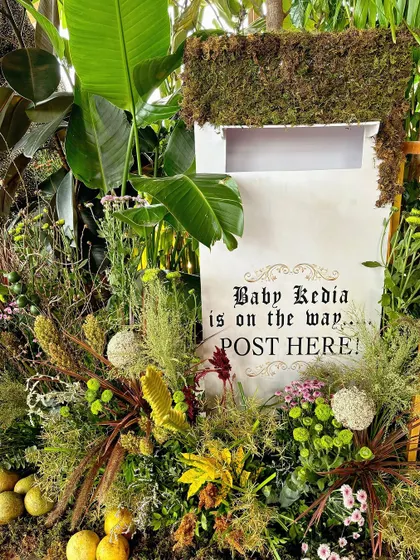 A close-up of the 'Baby Kedia is on the way' mailbox, a creative way to collect cards and well wishes.
