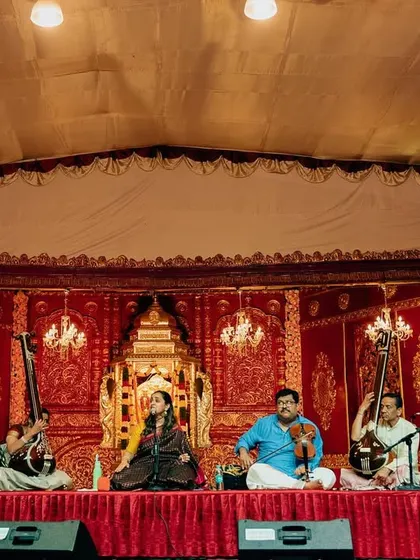 A full view of the stage at Sree Ramaseva Mandali. The traditional backdrop and the attentive audience create a perfect setting for a pure classical music experience.