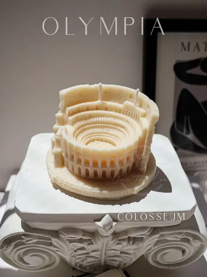 The Colosseum candle from my Olympia collection, presented on a decorative pillar. It's a multi-wick candle that creates a beautiful effect when lit.