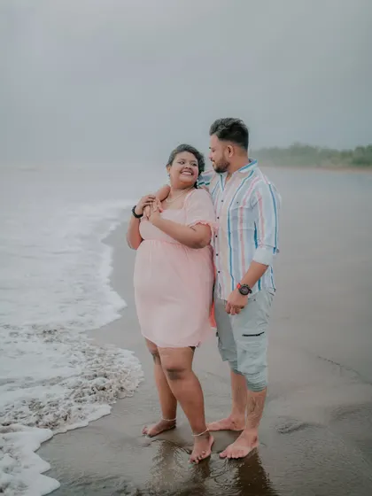 A lovely portrait of a couple enjoying the sea breeze on the beach.