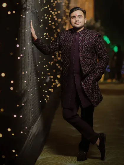 A stylish full-length portrait of the groom against a wall of lights. We know how to use the decor to create dynamic and interesting shots for our grooms.