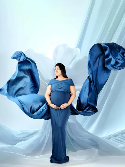 A powerful and artistic shot using flowing blue fabric to create the shape of wings. This is a creative technique I use to add drama and movement to your portraits.
