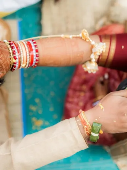 The 'Jeelakarra Bellam' ritual from a Telugu wedding, where a paste of cumin and jaggery is placed on the couple's heads. This unique overhead shot captures the symbolism and connection of the moment.
