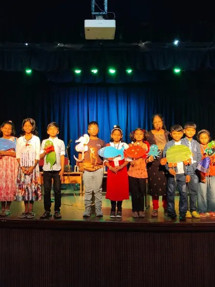 A Children's Day special, where our certified storytellers conducted sessions in various schools. Here, children are on stage with their own puppet creations after an engaging session.