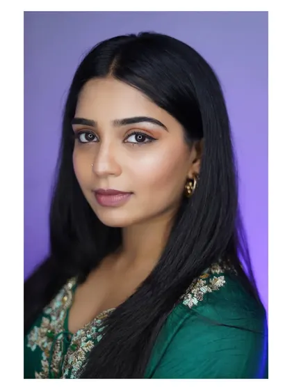 A clean and classic headshot against a soft purple background, perfect for an actor's portfolio.