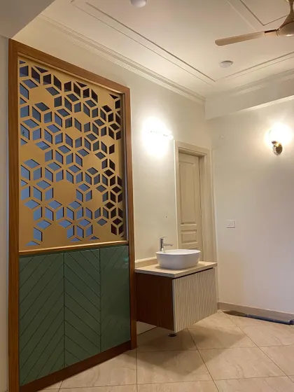A clearer, finished view of the partition and vanity unit. The combination of geometric patterns, colors, and textures makes this a standout feature.