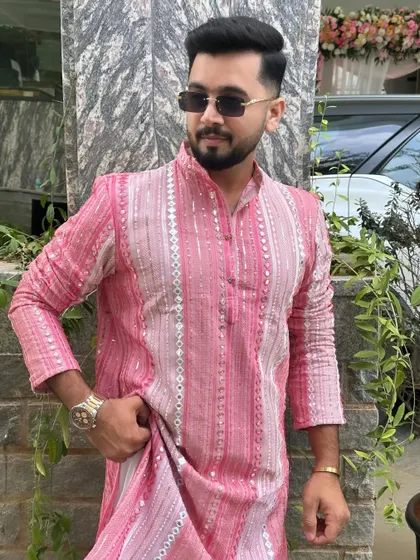 A closer look at the intricate sequin work on my pink kurta. The details matter, and I always choose outfits that stand out.