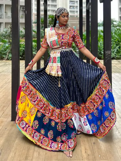 A full-length shot displaying the beautiful flare and vibrant colors of this traditional patchwork chaniya choli.