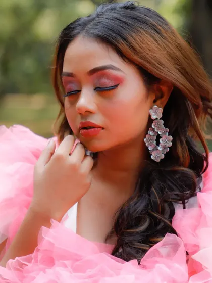 A detailed close-up of the makeup for the pink gown shoot. This shot highlights the blended pink eyeshadow and sharp winged eyeliner, complementing the whimsical theme.