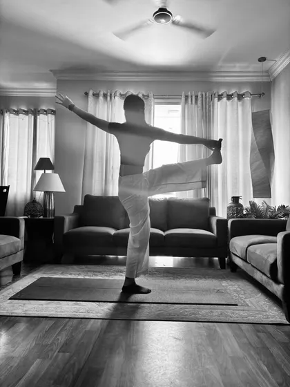 Standing big toe hold in black and white, one leg out to the side.