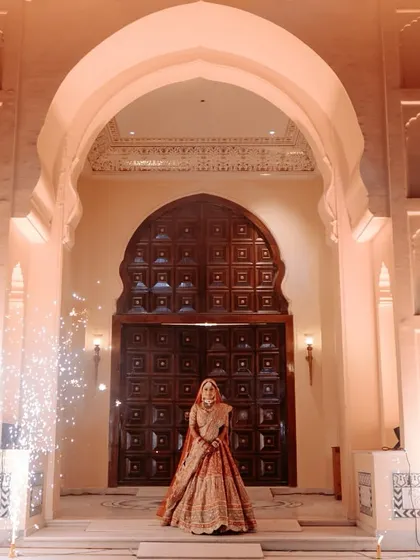 A bride's entry should be nothing short of majestic. We conceptualized this royal procession with a stunning architectural backdrop and perfectly timed cold pyros to create a truly regal and unforgettable varmala moment.
