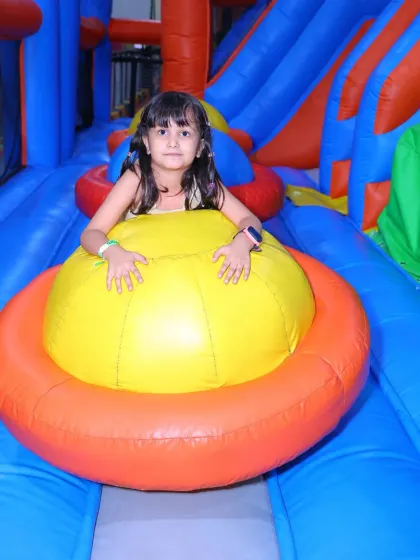 A young girl having a blast in one of the colorful sections of our inflatable obstacle course.