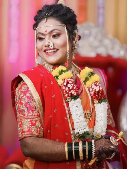 A candid portrait of a bride during her wedding ceremony, her happy expression captured in a moment of celebration.