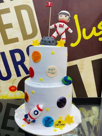 A full view of the 5kg, two-tiered space exploration cake, ready for a cosmic celebration.