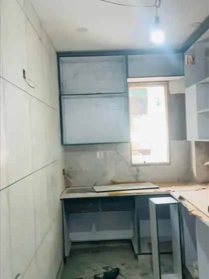The initial phase of a kitchen renovation. This shows the bare structure and cabinet carcasses being installed, which is the foundation of a great kitchen.