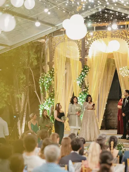 The reception stage, glowing under a transparent tent with hanging lanterns.