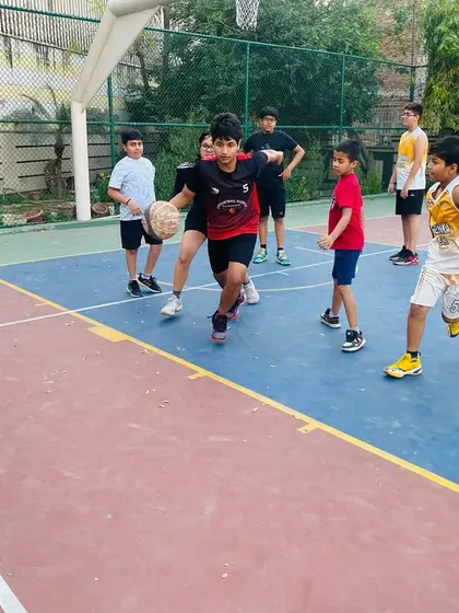 A young player in our junior program learning to handle the ball against a defender.