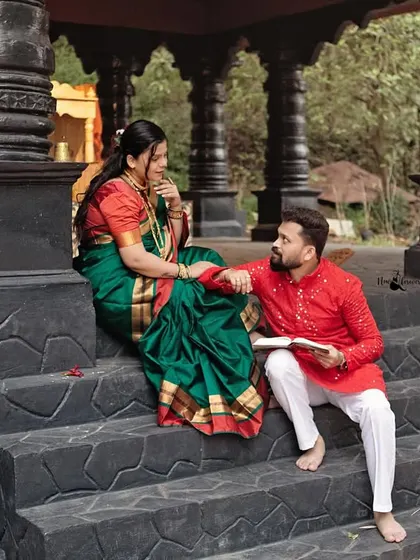 He reads to her as they sit on the temple steps. This is a beautiful storytelling image, suggesting shared dreams and quiet moments together.