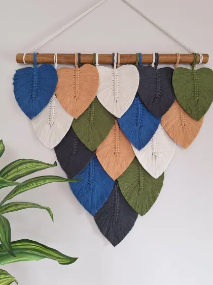 We love bringing the textures and colors of nature into your home. This macrame leaf wall hanging is handcrafted with natural cotton and can be customized with your favorite color palette to create the perfect earthy, cozy vibe for your living room or bedroom.