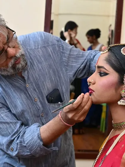 The transformation into a performer begins backstage. Here, the intricate process of applying stage makeup for my student Anvita Jain is underway, preparing her for her arangetram.