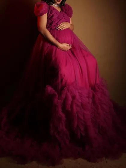 This close-up shot focuses on the beautiful bump and the texture of the magenta gown. My maternity dresses are designed to flatter your changing shape and make you feel amazing.