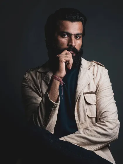 A classic, thoughtful portrait of a male model. The lighting is carefully controlled to sculpt the face and draw attention to the eyes, making for a compelling headshot.