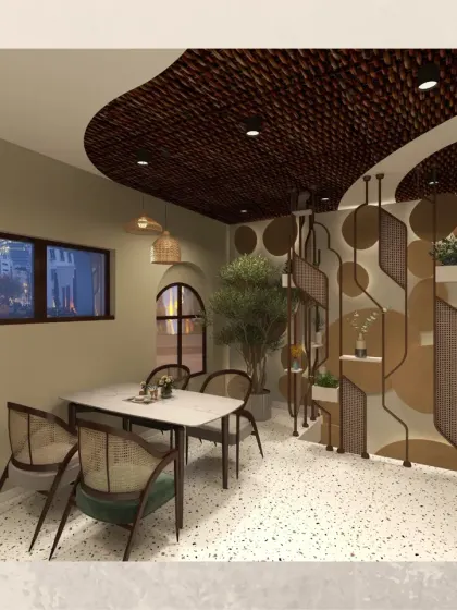 This view highlights a unique metal partition that acts as both a decorative element and a plant holder. It divides the space subtly while adding an artistic, modern touch to the cafe's interior.