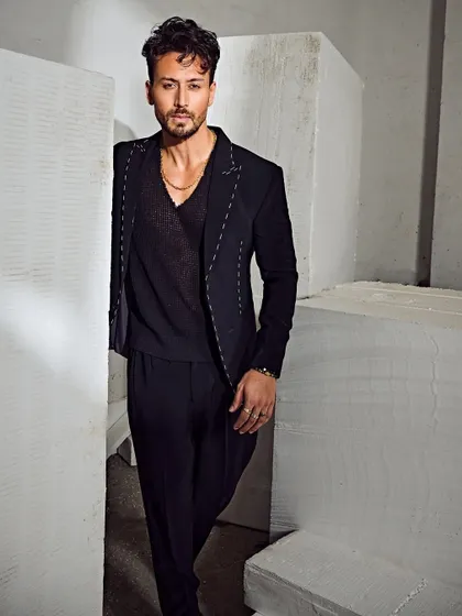 A sharp, modern take on suiting for Tiger Shroff. The contrasting white stitching adds a graphic, edgy detail to the all-black look.