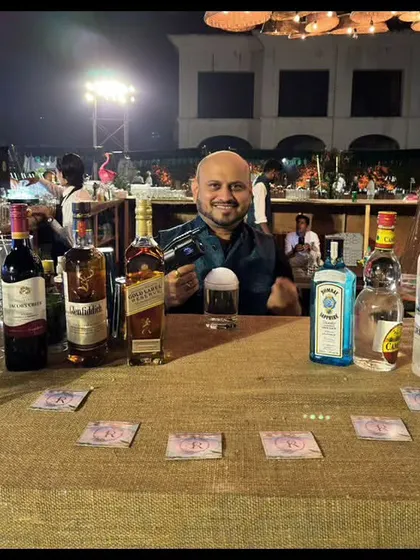 A simple yet effective bar setup for an outdoor event. The burlap-covered table and display of premium spirits like Johnnie Walker and Grey Goose show that we can create a great bar experience in any setting.