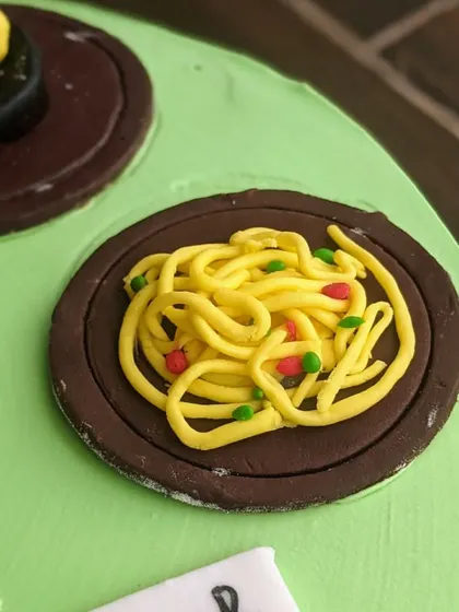 Who wants some noodles? This is another one of my hand-sculpted mini food toppers, showing a plate of delicious noodles, perfect for a foodie's birthday cake.