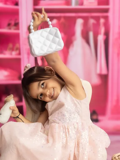The big sister strikes a pose in the princess-themed shoot, full of personality and fun.