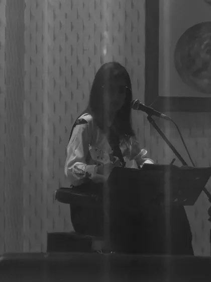 I'm at the microphone behind my music stand in this black-and-white view of the private-celebration guitar set.
