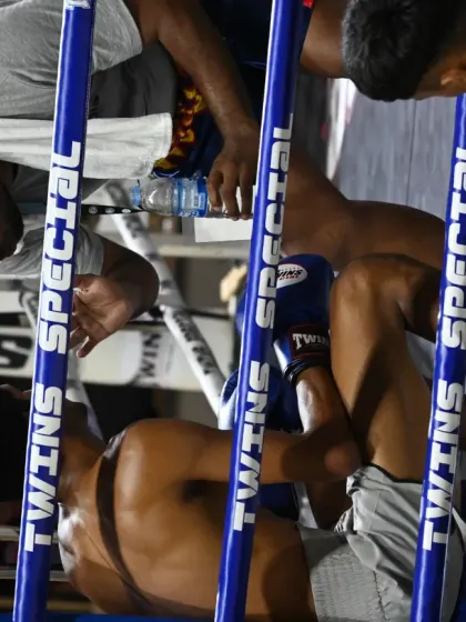 A moment of recovery and strategy in the corner. The seconds between rounds are vital for a fighter to regroup and listen to their coaches.