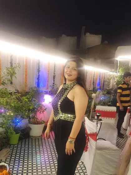 A candid shot of the client in her black jumpsuit at a party. It's a versatile piece that's perfect for celebrating with friends and family.