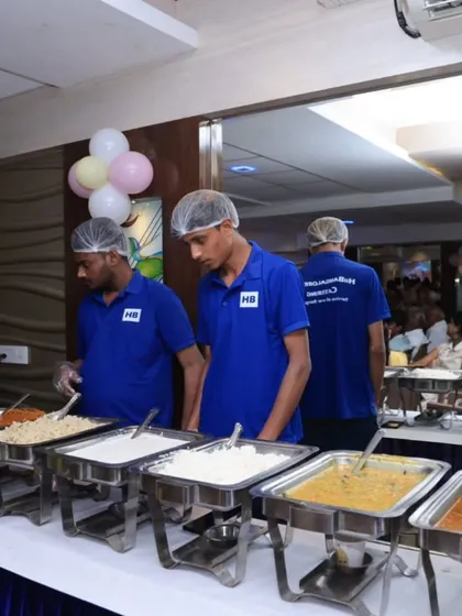 Our staff attending to the buffet line, ready to assist guests and manage the flow during a busy event.