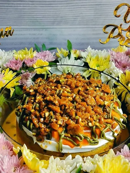 A straight-on shot of the Mother's Day mango pistachio tres leches hamper, highlighting the balance between the cake and the floral arrangement.