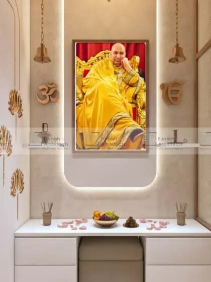 A serene and modern pooja space. The design is minimalist, with a simple white console, soft backlighting, and symbolic brass motifs. It's a peaceful corner for prayer and meditation.